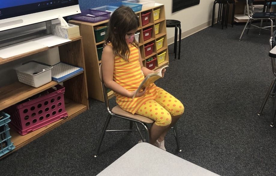 girl reading wearing a mask